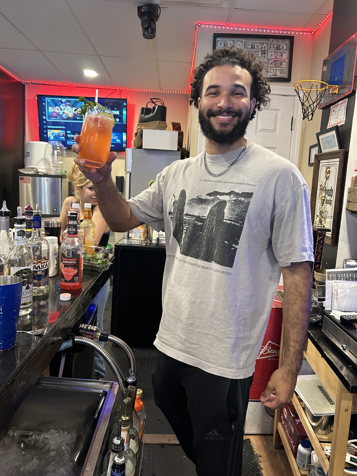 Bartender presenting a finished cocktail after practice