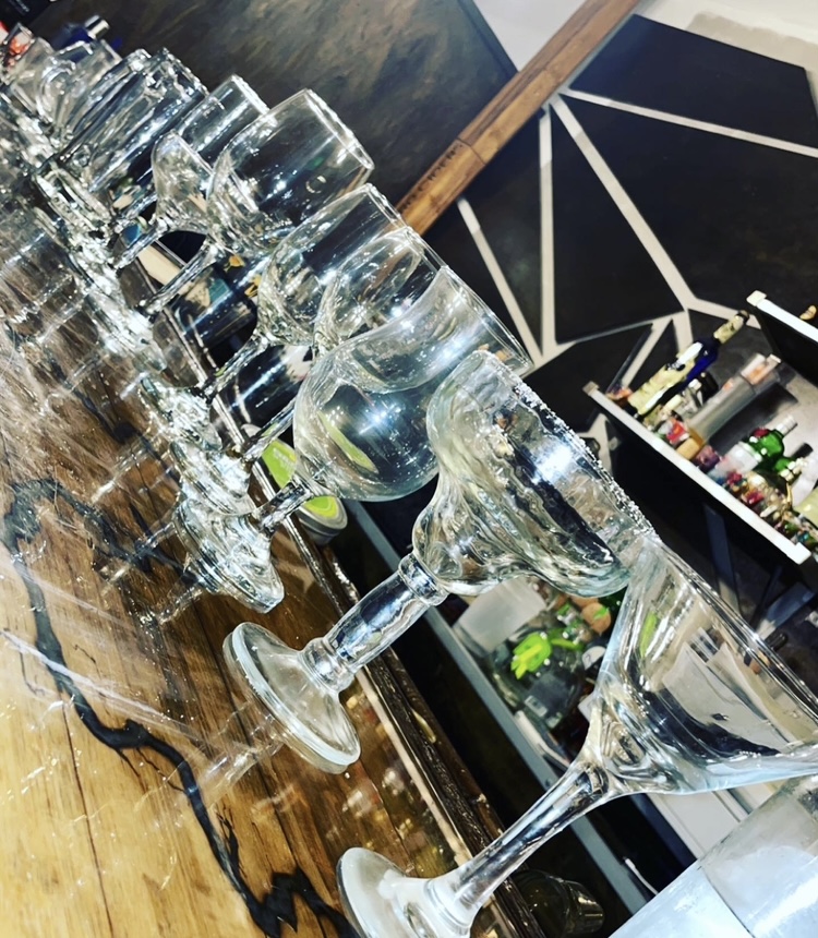 Glassware and bar tools prepared for hands-on bartender training