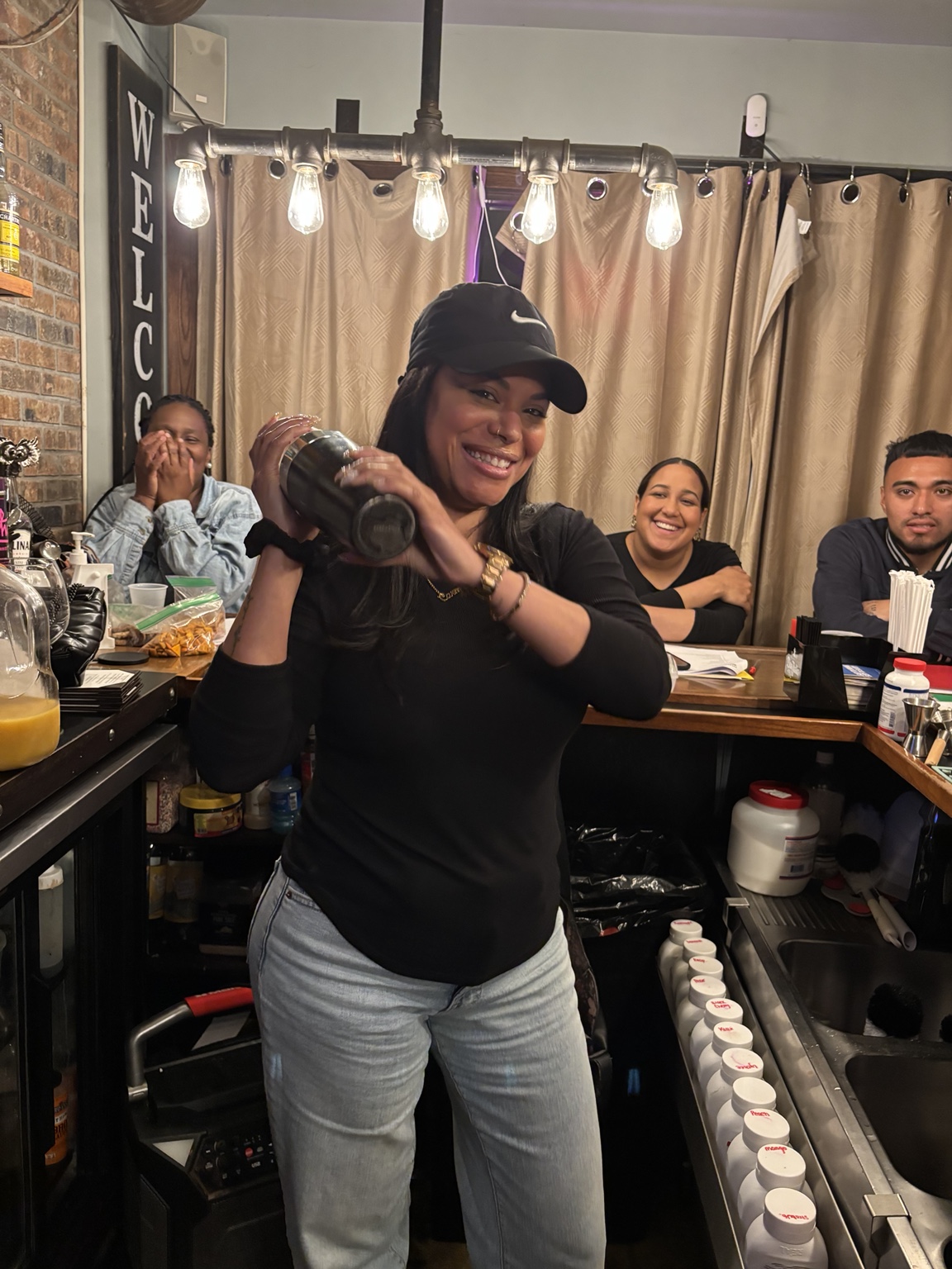 Student practicing with a cocktail shaker during a bartender class