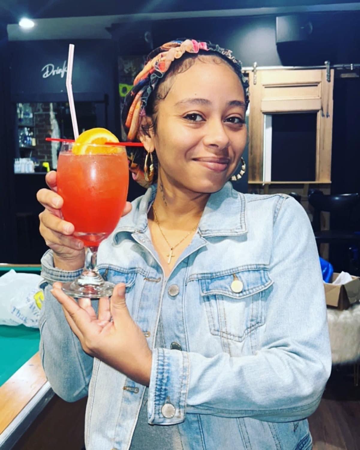 Bartending student presenting a completed cocktail